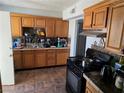 Functional kitchen featuring wood cabinets, a tile backsplash, and modern appliances for convenient meal preparation at 2725 Webster St, North Las Vegas, NV 89030
