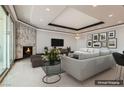 Elegant living room with a marble fireplace, recessed lighting, and stylish contemporary furnishings, virtually staged at 2777 Paradise Rd # 2701, Las Vegas, NV 89109