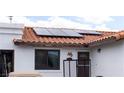 Charming exterior showcases solar panels on a red tile roof, enhancing energy efficiency at 2822 La Palma Dr, Laughlin, NV 89029