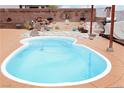 Inviting kidney-shaped pool with rock waterfall feature in a beautifully landscaped backyard oasis at 2822 La Palma Dr, Laughlin, NV 89029