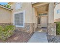 Inviting front entrance with brick accents and well-kept landscaping, creating a warm welcome at 285 Canyon Spirit Dr, Henderson, NV 89012