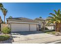 Well-maintained single-story home with three-car garage, mature landscaping, and desert-friendly design at 285 Canyon Spirit Dr, Henderson, NV 89012