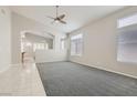 Bright living room with plush carpeting, vaulted ceilings, and large windows for abundant natural light at 285 Canyon Spirit Dr, Henderson, NV 89012