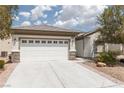 Attractive home with desert landscaping, a concrete driveway, and a bright white garage door at 3312 Lapwing Dr, North Las Vegas, NV 89084