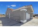 Large garage with an orange tile roof, neutral stucco, and a concrete driveway at 3326 Mount Charleston Dr, Pahrump, NV 89048