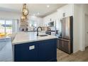 Modern kitchen featuring a large island, stainless steel appliances, and sleek cabinetry at 3440 Ernest St, North Las Vegas, NV 89032
