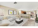 Bright living room with stylish furniture, modern decor, and an open view to the kitchen at 3619 Hat Rock Ct, Las Vegas, NV 89129