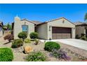 Beautiful desert home with a two-car garage and lush, desert-friendly landscaping at 3712 Rocklin Peak Ave, North Las Vegas, NV 89081