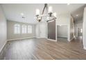 Spacious living room featuring wood-look tile flooring and arched windows for natural light at 3882 Genoa Dr, Las Vegas, NV 89141