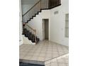 Entryway featuring light tile flooring and a staircase leading to the second level at 5024 Saint Annes Dr, Las Vegas, NV 89149