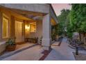Welcoming front porch with decorative plants, offering a cozy entrance to the home and comfortable seating at 5142 Southern Hills Ln, Las Vegas, NV 89113