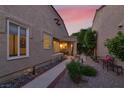 Inviting front yard with walkway, mature landscaping and charming exterior of the home, bathed in the warm light of sunset at 5142 Southern Hills Ln, Las Vegas, NV 89113