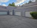 Multiple garage doors with an asphalt driveway on a sunny day at 5250 S Rainbow Blvd # 1140, Las Vegas, NV 89118