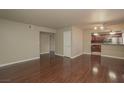Large living room with hardwood floors and open access to the kitchen and stainless steel appliances at 5383 Indian River Dr # 323, Las Vegas, NV 89103