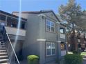 Exterior view of a multi-story condo building with a staircase, balconies, and well-maintained landscaping at 555 E Silverado Ranch Blvd # 2052, Las Vegas, NV 89183