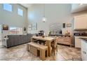 Dining area with large windows, wooden table, adjacent to the kitchen at 5662 Oak Bend Dr, Las Vegas, NV 89135