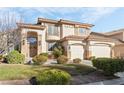 Beautiful two-story home featuring a balcony, complemented by lush landscaping and a welcoming entrance at 5684 Benevento Ct, Las Vegas, NV 89141