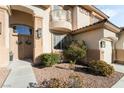 Inviting front entrance with double doors, decorative wreaths, and manicured landscaping for added curb appeal at 5684 Benevento Ct, Las Vegas, NV 89141