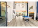 Spacious living room boasts high ceilings, a fireplace, a pool table, and seamless indoor-outdoor living at 6315 Bellisima St, Las Vegas, NV 89118