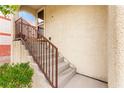Stairway leading to the front door of a townhome with iron railing at 6488 Bentley Wood Ct, Las Vegas, NV 89130