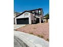 Two-story home featuring a spacious two-car garage and low maintenance desert landscaping at 6640 Crosstimber Ct, Las Vegas, NV 89108