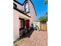 Inviting front entrance with red door, small potted plants, and desert landscaping at 6640 Crosstimber Ct, Las Vegas, NV 89108