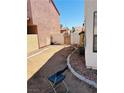 Side yard with dirt landscaping and block wall at 6640 Crosstimber Ct, Las Vegas, NV 89108