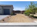 Charming single-story home featuring a low-maintenance desert landscape and gated driveway at 73 Hawk Ave, Pahrump, NV 89060