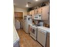 Functional kitchen featuring white appliances and adjoining laundry area for added convenience at 7400 W Flamingo Rd # 1090, Las Vegas, NV 89147