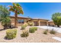 Charming single-story home featuring well-maintained desert landscaping, including a stately palm tree at 7434 Eggshell Dr, North Las Vegas, NV 89084