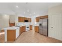 Bright kitchen featuring tile floors, white appliances, and ample cabinet space for storage and meal preparation at 8040 Tailwind Ave, Las Vegas, NV 89131