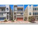 Modern three-story home featuring a brick driveway, balcony, and roof deck at 8092 Haywood Estate Ave, Las Vegas, NV 89113