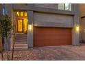 Front exterior view of the house featuring a modern two-car garage and entryway with a stylish front door at 8092 Haywood Estate Ave, Las Vegas, NV 89113