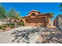 Inviting single-story home featuring a two-car garage and a desert landscape, plus an extended driveway at 819 Arrowhead Trl, Henderson, NV 89002
