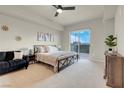 Spacious main bedroom featuring a ceiling fan, exterior balcony access, and comfortable furnishings at 8255 One Las Vegas Blvd # 504, Las Vegas, NV 89123