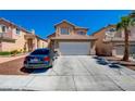 Attractive two-story home with a tile roof, attached garage, and a concrete driveway in a suburban neighborhood at 8370 Lost Lake Ct, Las Vegas, NV 89147
