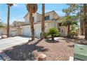 Charming two-story home featuring a three car garage and desert landscaping in a suburban neighborhood at 9923 Sierra Canyon Way, Las Vegas, NV 89147