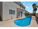 Private backyard featuring a custom pool with steps and a unique curved design at 9923 Sierra Canyon Way, Las Vegas, NV 89147