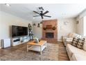 Inviting living room featuring a brick fireplace and hardwood floors, great for entertaining at 100 Walker Way, Boulder City, NV 89005