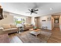 Bright living room featuring beautiful wood flooring, comfortable seating, and a large window at 100 Walker Way, Boulder City, NV 89005