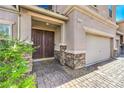 Inviting front entrance features a double door, brick pathway and stonework adding to the curb appeal at 1213 High Altitude Ave, North Las Vegas, NV 89032