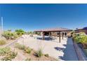 Outdoor oasis featuring a covered patio, a pool, and a spacious stone patio at 12168 Dorada Coast Ave, Las Vegas, NV 89138