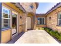 Charming front entrance with stone accents and a welcoming pathway, enhancing the home's curb appeal at 12168 Dorada Coast Ave, Las Vegas, NV 89138