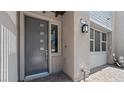 Contemporary front entry with a modern gray door, stylish hardware, and accent lighting at 1467 Melodic Lark Ln, Las Vegas, NV 89138