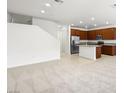 Open-concept living area flowing into a kitchen with stainless steel appliances and a center island at 1467 Melodic Lark Ln, Las Vegas, NV 89138