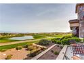 Scenic view of the golf course and water feature from an outdoor patio with seating at 2244 Shadow Canyon Dr, Henderson, NV 89044