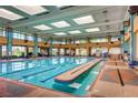 Spacious indoor pool with skylights, large windows, and plenty of deck space at 2244 Shadow Canyon Dr, Henderson, NV 89044