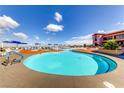 Outdoor resort-style pool with ample seating, umbrellas and beautiful blue skies at 2244 Shadow Canyon Dr, Henderson, NV 89044