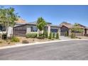 Inviting single-story home featuring well-maintained landscaping and a convenient two-car garage at 25 Red Creek Bluff St, Henderson, NV 89011