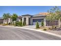 Charming single-story home with a neatly landscaped front yard and a spacious two-car garage at 25 Red Creek Bluff St, Henderson, NV 89011